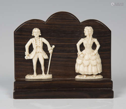 A pair of 19th century carved ivory flatback figures of a lady and gentleman, applied to a stepped