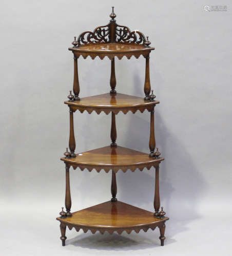 A Victorian figured mahogany graduated four-tier bowfront whatnot with fretwork frieze and aprons,