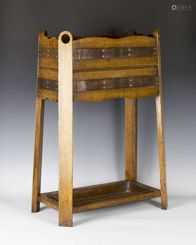 An early 20th century Arts and Crafts oak and copper mounted stick stand, in the manner of