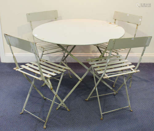 A 20th century green painted metal folding garden table, diameter 97cm, and a set of four folding