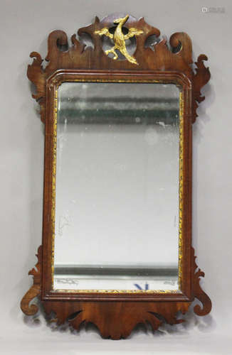 A George III mahogany fretwork framed wall mirror, the pierced top carved and gilded with a phoenix,