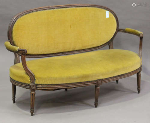 A 19th century French Louis XVI style walnut showframe settee, raised on fluted tapering legs,