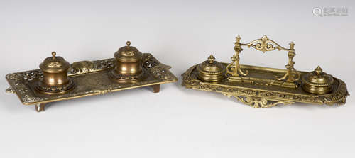 A late Victorian Baroque Revival cast brass inkstand, width 35cm, together with another similar