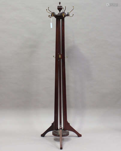 An Edwardian mahogany coat stand, on fluted tripod supports, height 205cm (some minor faults).