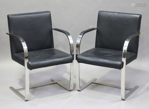 A pair of modern chromium plated metal and black leather cantilever armchairs, height 83cm, width