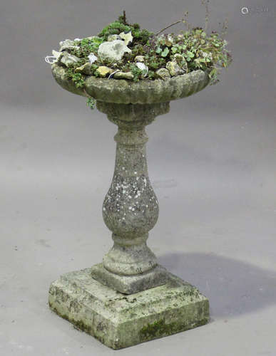 A 20th century cast composition stone bird bath, the reeded circular bowl planted with a mix of