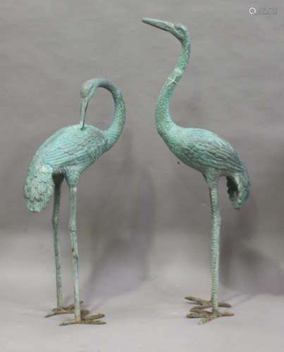 A pair of late 20th century verdigris cast bronze garden models of standing cranes, height 143cm (