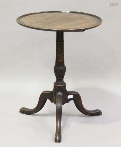 A 19th century mahogany tip-top wine table, the dished top on a turned stem and tripod legs,