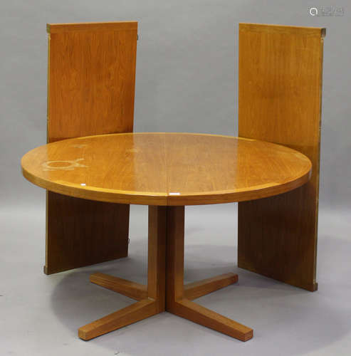 A mid-20th century Danish teak extending dining table, designed by John Mortensen for Heltborg