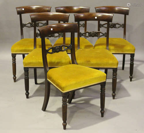 A set of six William IV mahogany bar back dining chairs, the pierced centre rails with carved