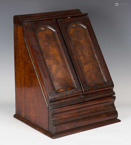 A mid-Victorian mahogany slope-fronted stationery box, the two arched panel doors enclosing a letter