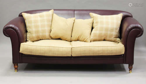 A modern maroon leather and chequered fabric settee, on turned legs and brass caps, height 85cm,