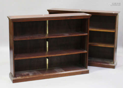 A pair of modern reproduction mahogany open bookcases with crossbanded tops and adjustable