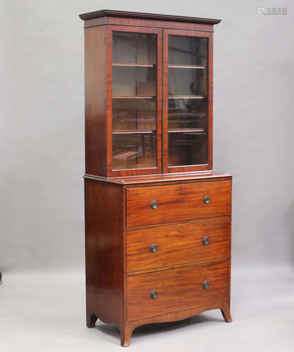 An early Victorian mahogany secrétaire bookcase cabinet, the glazed top enclosing three adjustable