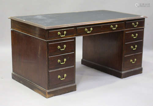 A mid-20th century reproduction mahogany twin-pedestal desk, fitted with an arrangement of nine