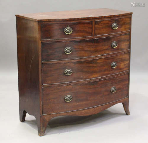 A Regency mahogany bowfront chest of two short and three graduated long drawers, on outswept bracket