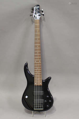 An electric five-string bass guitar, the head detailed 'Cruiser by Crafter', together with soft