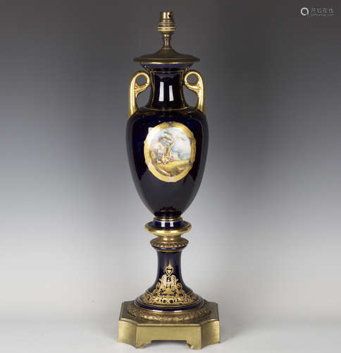 An early 20th century Continental porcelain and brass mounted table lamp, the blue glazed ovoid body