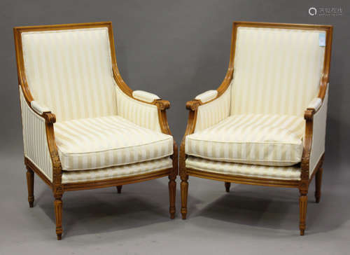 A pair of modern Louis XVI style showframe armchairs, upholstered in a cream stripe damask, the