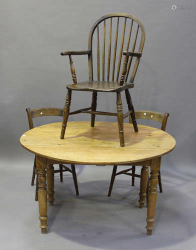 A late Victorian pine circular drop-flap kitchen table, fitted with a single drawer, height 76cm,