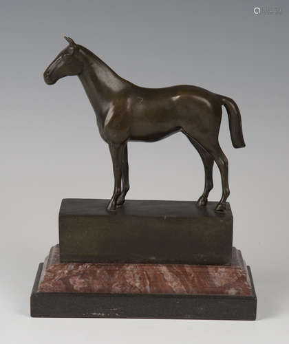 A late 20th century brown patinated cast bronze model of a horse standing four-square, bearing