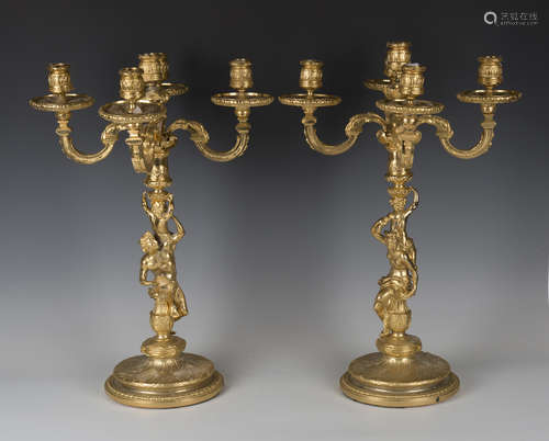 A pair of late 20th century cast gilt metal five-light candelabra with figural stems and circular