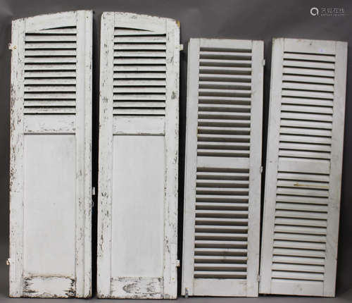 Two pair of early 20th century white painted French louvre shutter doors, comprising an arched pair,