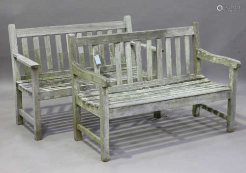 Two 20th century wooden slatted garden benches, widths 122cm (weathered and faults).Buyer’s
