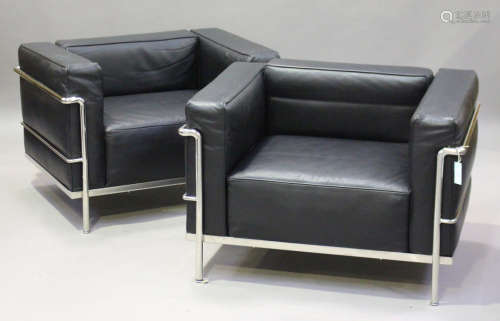 A pair of modern LC2 style armchairs, after a design by Le Corbusier, the black leather cushions