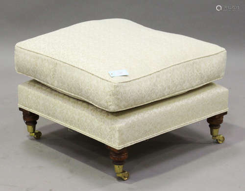 An Ashley Lawrence square footstool, on turned tapering legs terminating in brass caps and