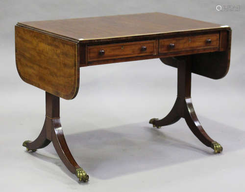 A Regency mahogany sofa table with rosewood crossbanding and boxwood stringing, fitted with two