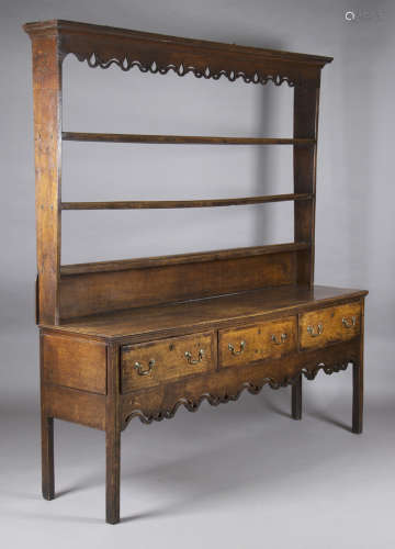 A George III North Country oak and mahogany crossbanded dresser, the shelf back and apron with