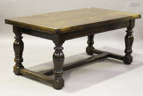 A modern Jacobean Revival oak drawleaf refectory table, raised on heavy turned baluster legs, height