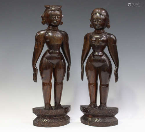 A pair of 20th century South Indian carved hardwood standing figures, height 47cm.Buyer’s Premium