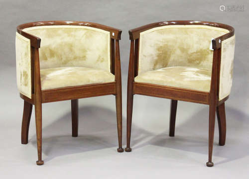 A pair of Edwardian Arts and Crafts style mahogany tub back chairs, the seat rails with chequer