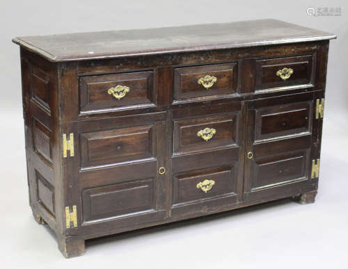 A mid-18th century oak dresser base, the moulded top above three drawers, two dummy drawers and