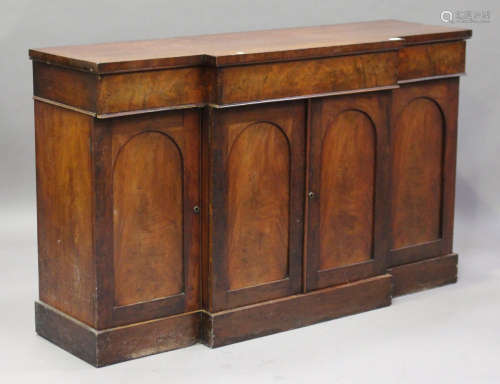 An early Victorian mahogany side cabinet, fitted with three drawers above arched panel doors, height