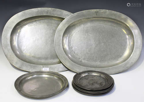 A selection of mainly 19th century pewter items, including two large oval platters, length 56cm,