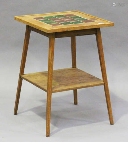 An Edwardian Arts and Crafts oak two-tier occasional table, possibly by Liberty & Co, the top