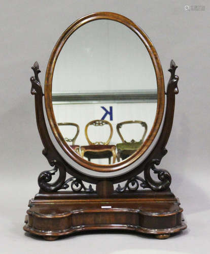 A late Victorian mahogany swing frame dressing table mirror, the serpentine base fitted with a