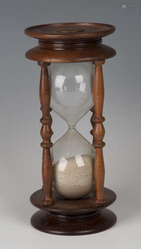 A late 20th century mahogany framed hour glass, height 26cm.Buyer’s Premium 29.4% (including VAT @