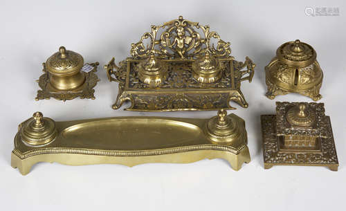 A late Victorian cast brass inkstand, decorated with cherubs and foliage, width 25cm, together