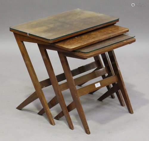 A mid-20th century walnut nest of three occasional tables, on angular legs, height 51cm, width 57cm,