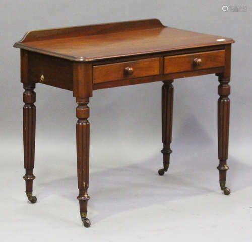 A mid-Victorian mahogany side table, raised on turned and reeded legs fitted with china castors,