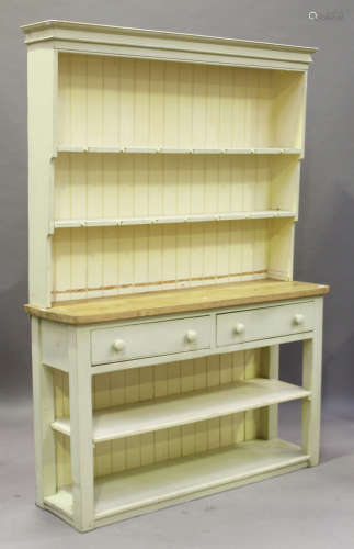 A 20th century cream painted pine dresser with shelf back above two short drawers, on block legs