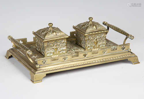 A late Victorian Gothic Revival cast brass inkstand, the two lidded inkwells flanked by spiral