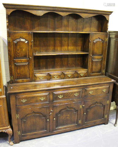 A 20th century Jacobean style oak dresser, the shelf back above drawers and cupboards, on stile