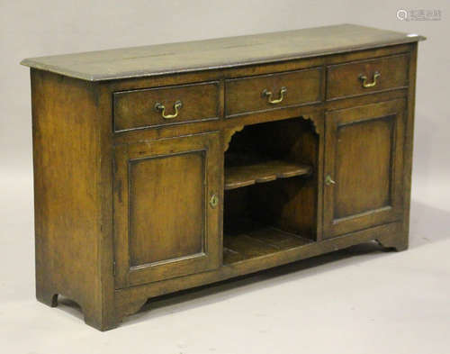 An 18th century style oak dresser base, the three drawers above an open shelf flanked by