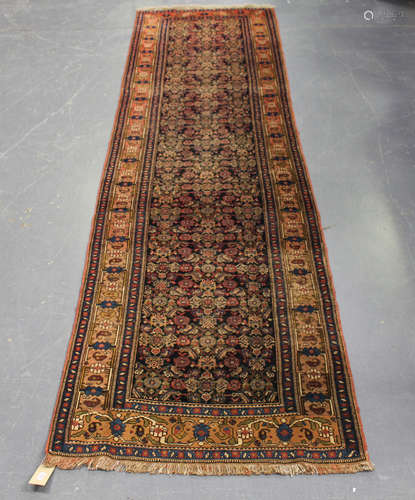 A Malayer runner, North-west Persia, early 20th century, the charcoal field with overall herati,