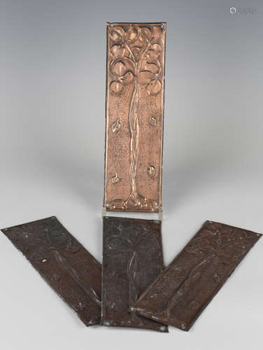 A set of four early 20th century Arts and Crafts pressed copper-plated door finger plates, in the